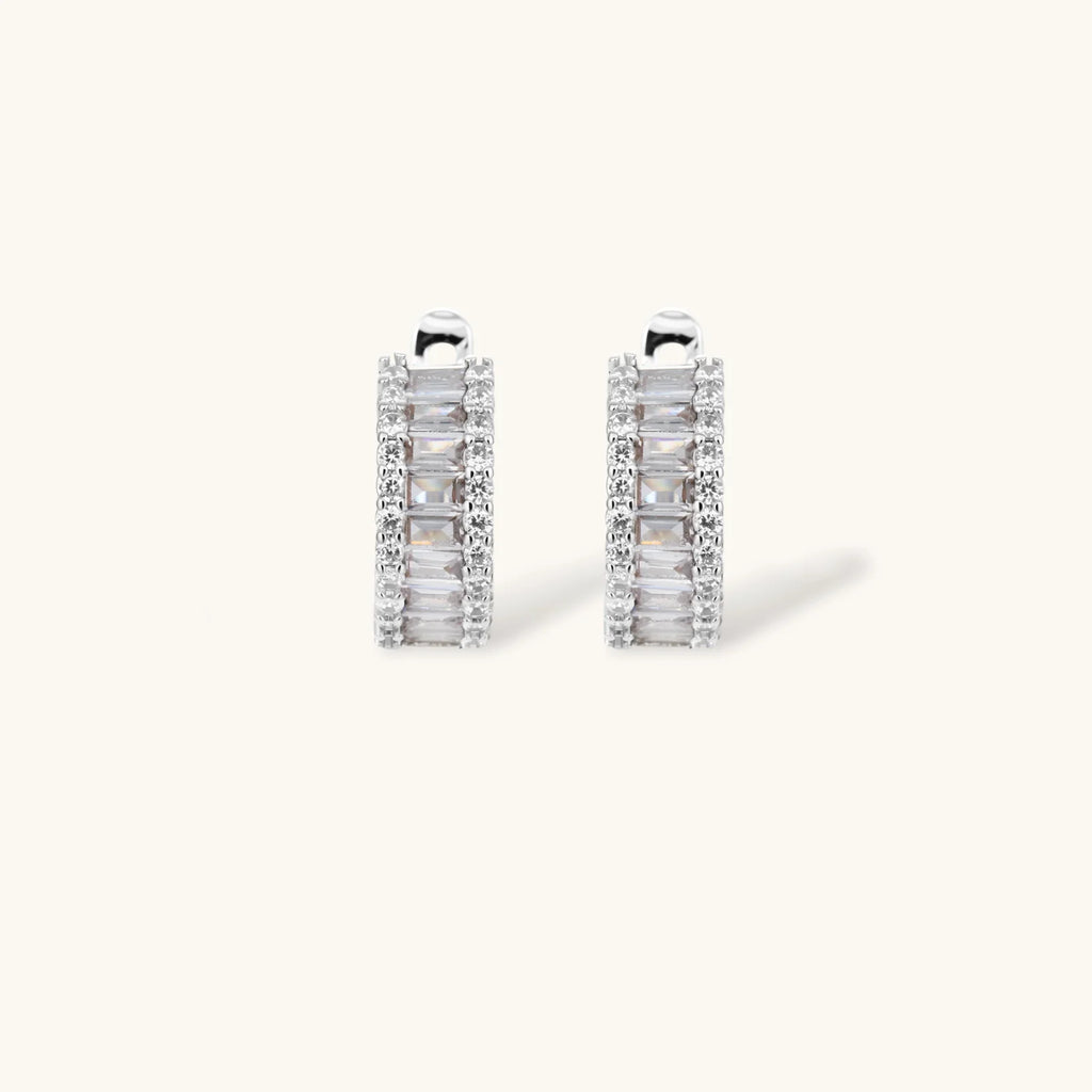 White gold plated necklace and hoop earrings featuring geometric ladder-pattern clear zirconia stones on neutral background.