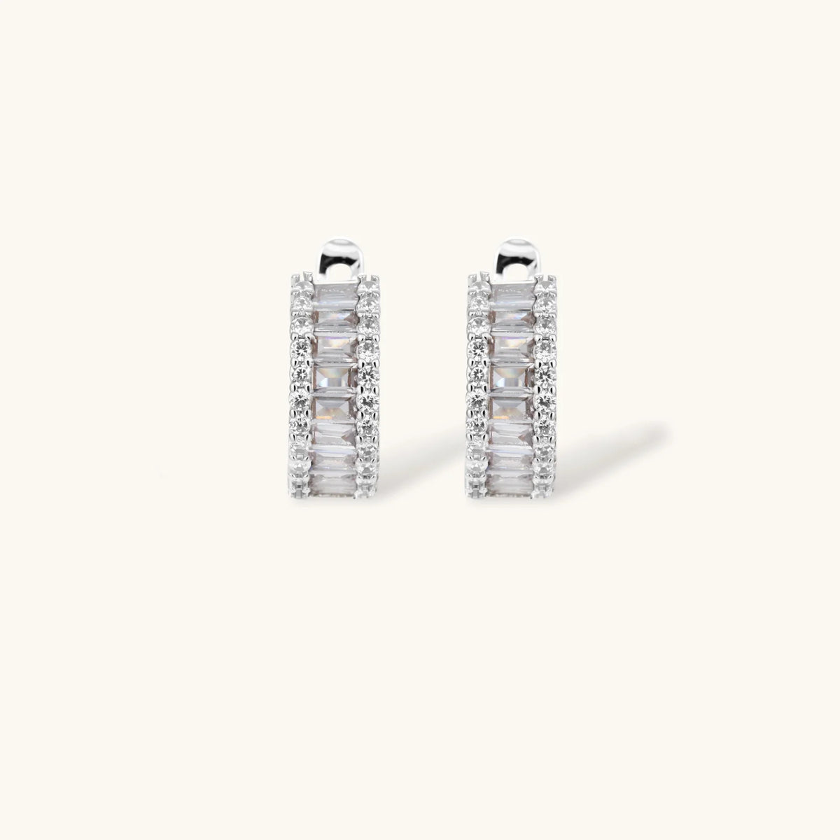 White gold plated necklace and hoop earrings featuring geometric ladder-pattern clear zirconia stones on neutral background.