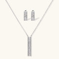 White gold plated necklace and hoop earrings featuring geometric ladder-pattern clear zirconia stones on neutral background.
