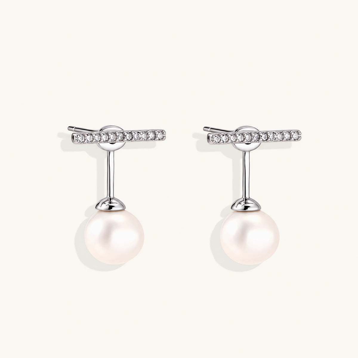 Rhodium-plated sterling silver ear jacket earrings with diamond-set horizontal bar and freshwater pearl drop