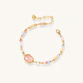 Delicate beaded bracelet with pastel rose quartz, pearls, and pink cushion-cut centerpiece in gold-plated setting